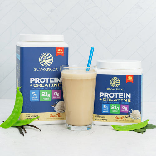 Sunwarrior vanilla protein and creatine powder containers with a smoothie in a glass and green leaves nearby