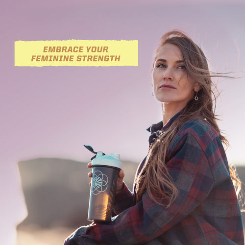 Woman outdoors at sunset holding a drink bottle with text "Embrace your feminine strength" in soft light