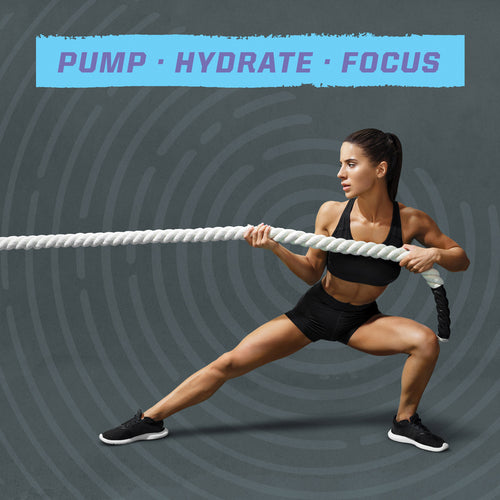 Athletic woman in black sportswear performing a side lunge while pulling a thick battle rope against a gray background with the words "PUMP HYDRATE FOCUS" above her.