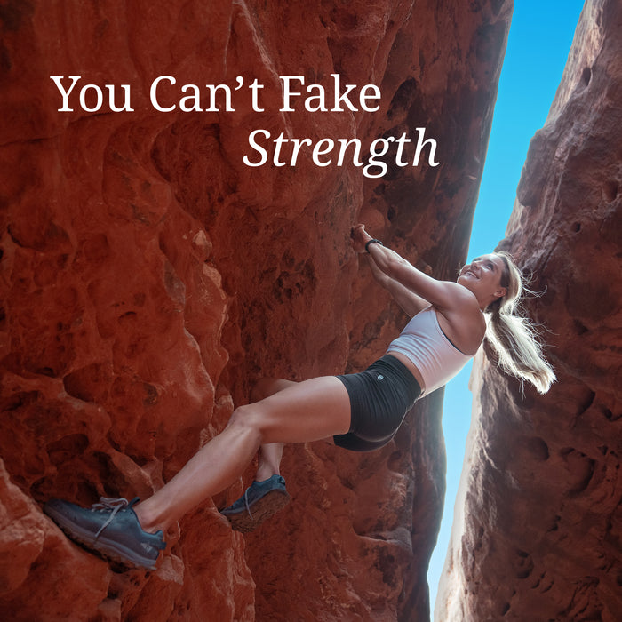 Woman rock climbing between red cliffs under clear blue sky with text 